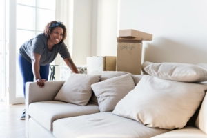 Woman moving a couch